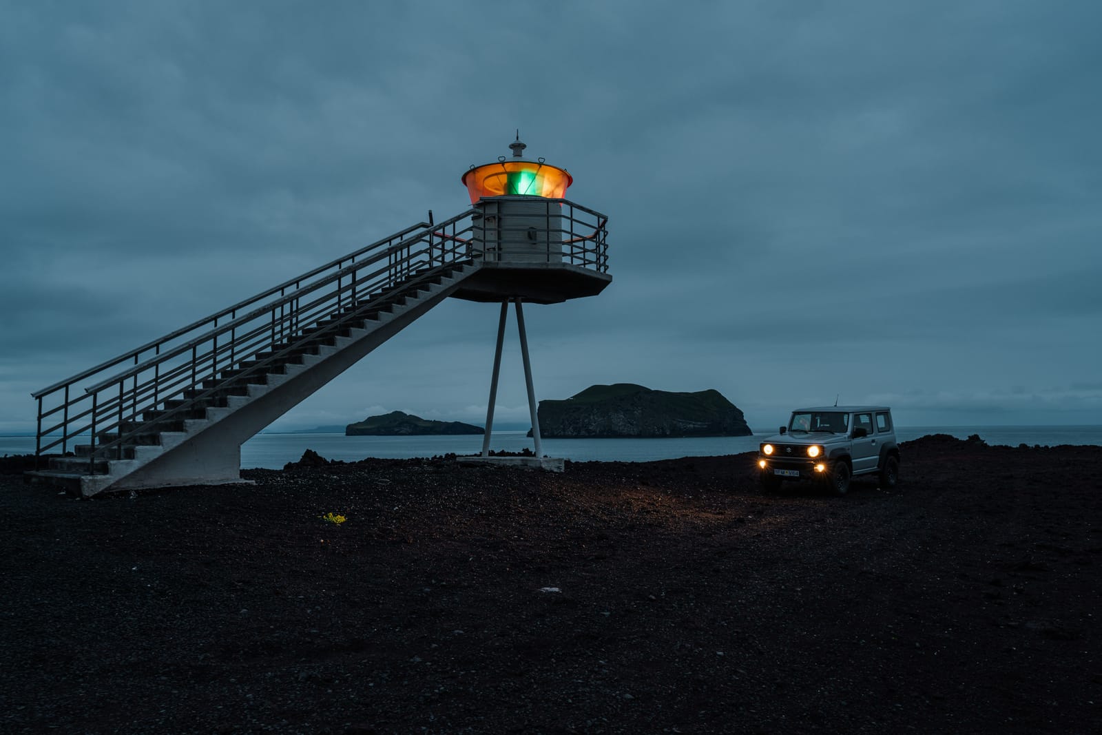 Dusk: elevated viewing platform, car light trails, black terrain.
